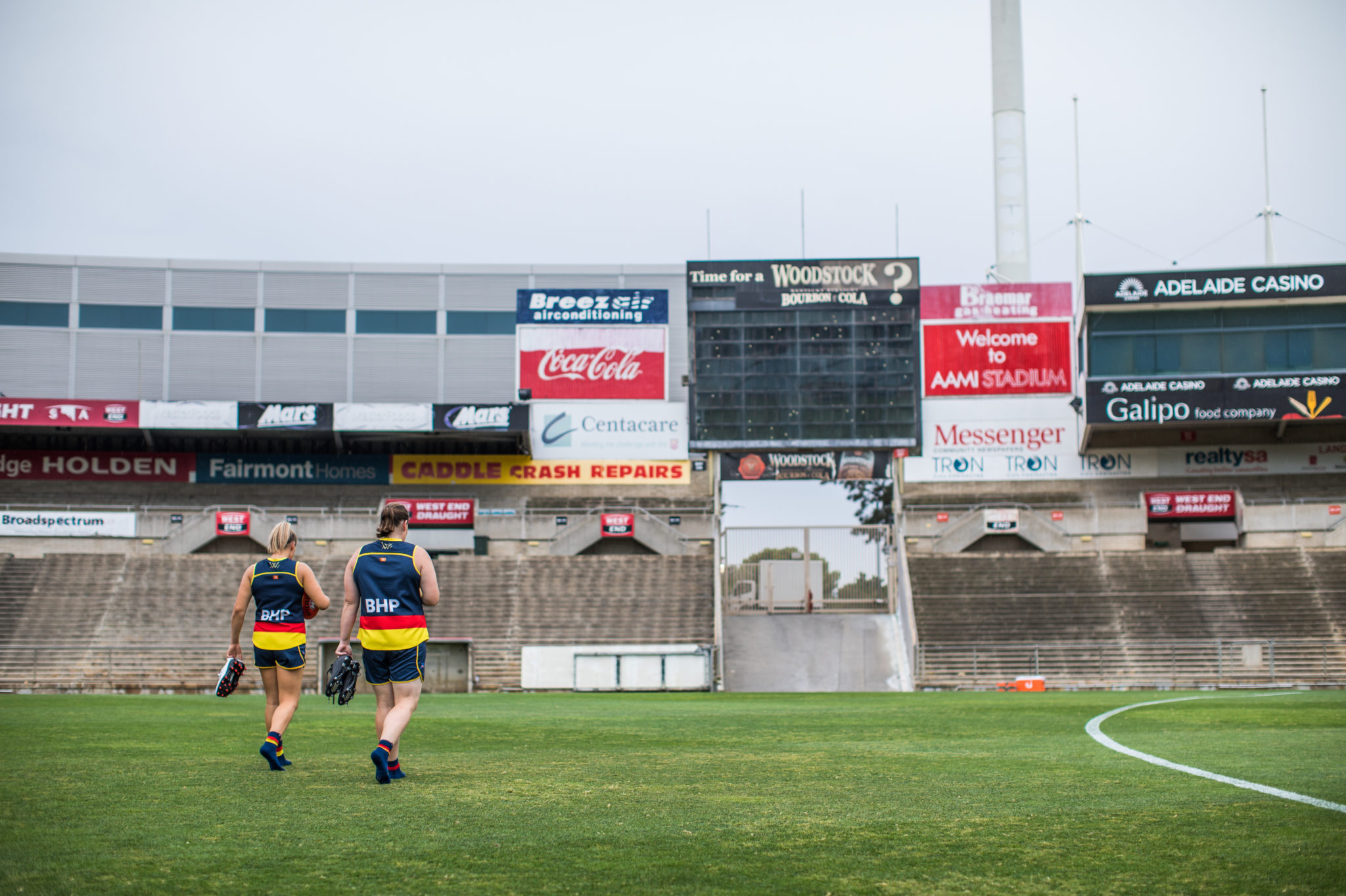 AFLW Crows players Sarah Perkins and Ebony Marinoff walking out of the West Lakes training grounds