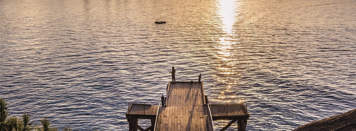 Lone person on Horseshoe Bay jetty.