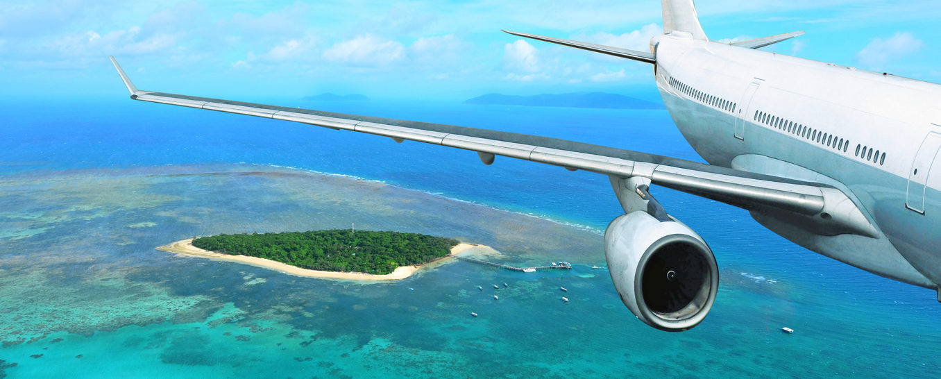 Plane flies over pristine waters of the Great Barrier Reef.