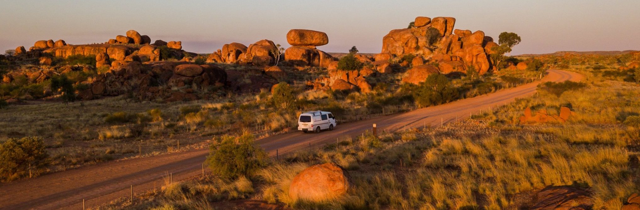 Travellers driving through Devils Marbles