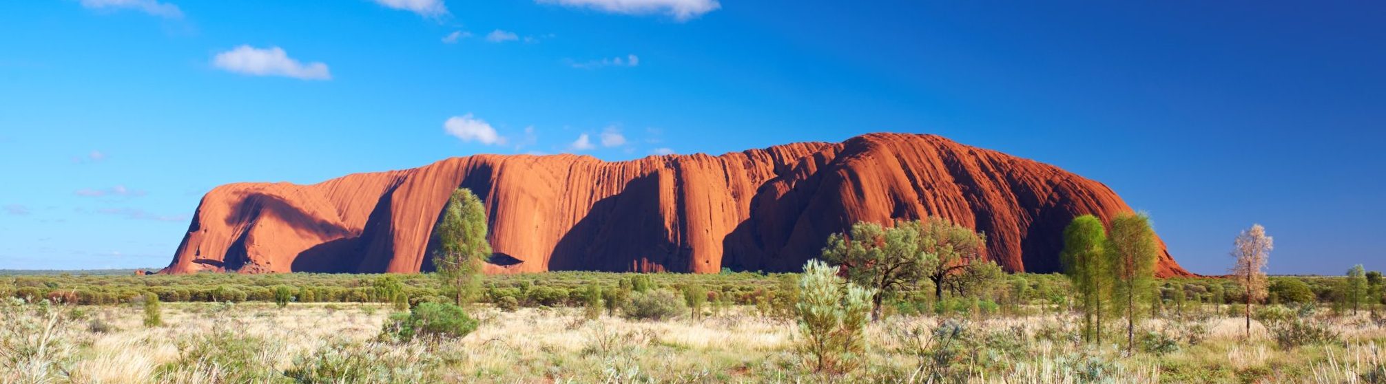 View of Uluru rising up from the desert