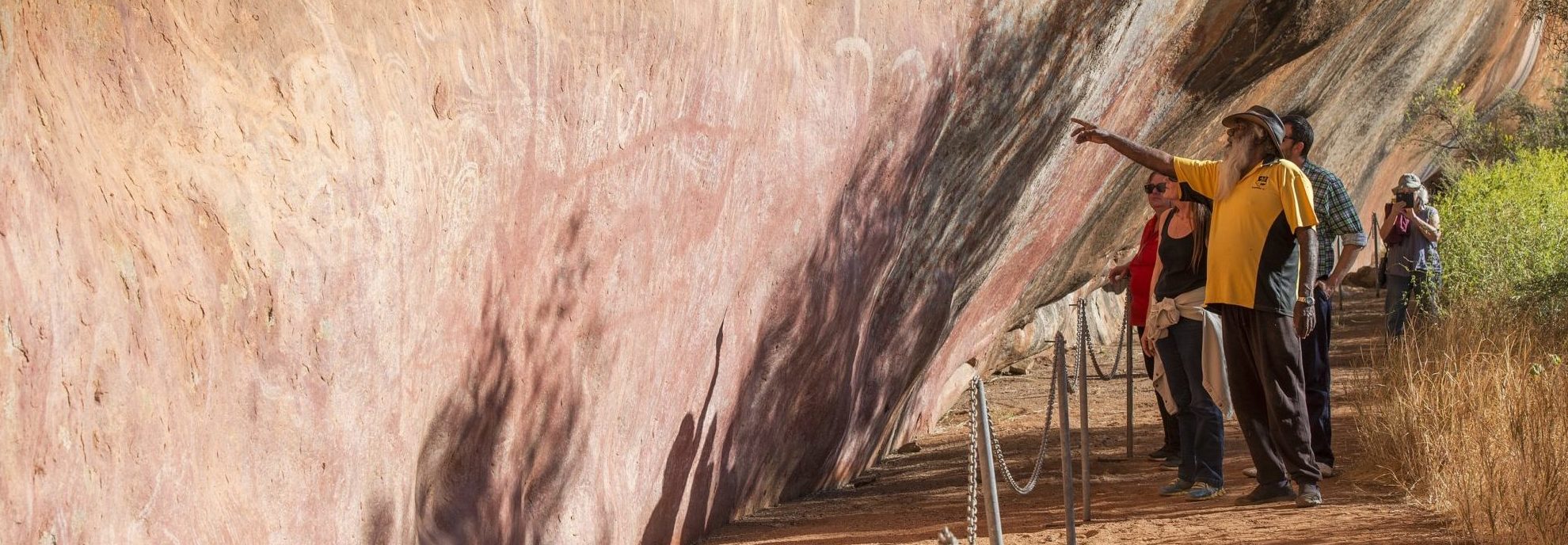 Guide showing visitors Aboriginal paintings on Walga Rock