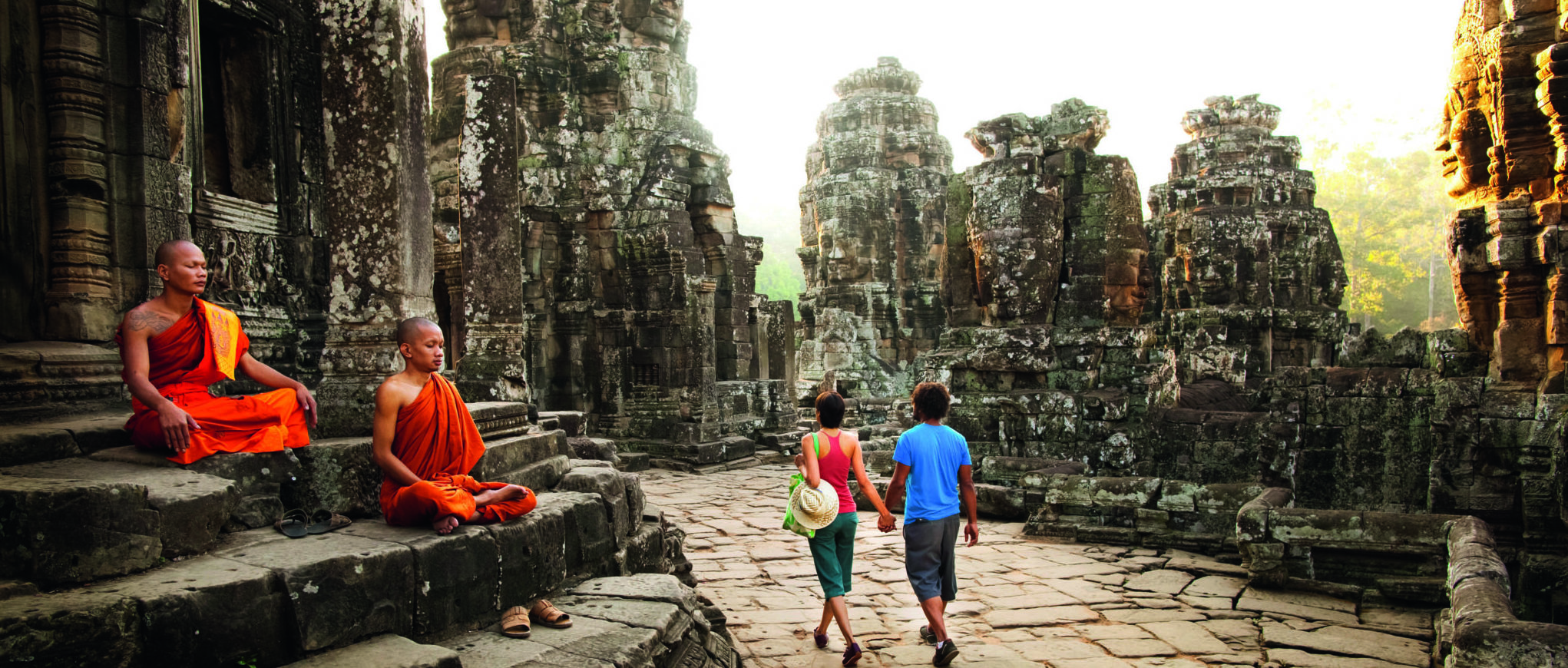 Couple visiting Buddhist temple, Angkor, Siem Reap, Cambodia