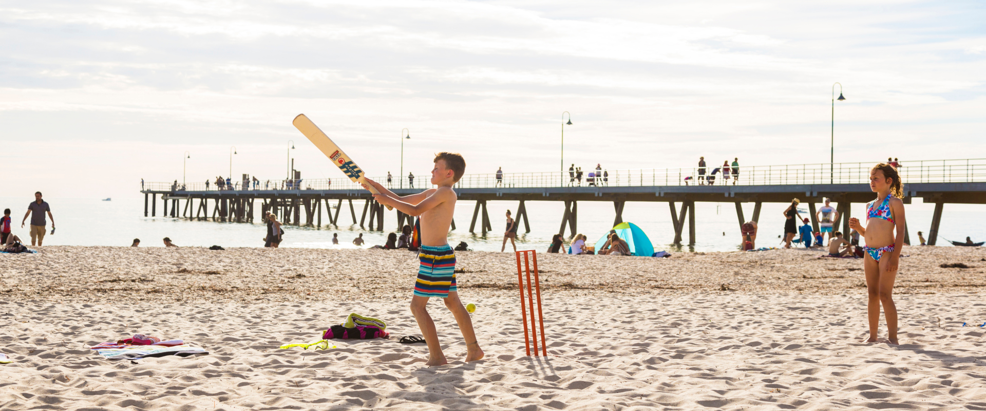 Beach cricket at Glenelg is a hit with the kids. Image: SATC/Andre Castellucci.